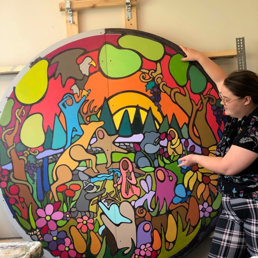 A side-by-side comparison of Portia "Po" Chapman’s "Exploring the Senses" mural showing the visual difference between one coat and two coats of opaque black line-work.