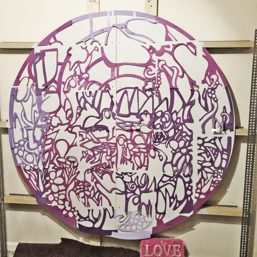 Kingston artist Portia "Po" Chapman’s "Exploring the Senses" mural design on a custom wall-mount easel, showing the transition from pen-and-ink drawing to a life-size template.