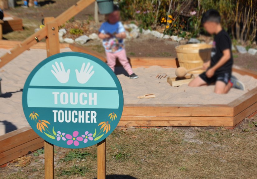 Kingston artist Portia "Po" Chapman hand painted sign, "Touch," in the Base 31 Sensory Garden.