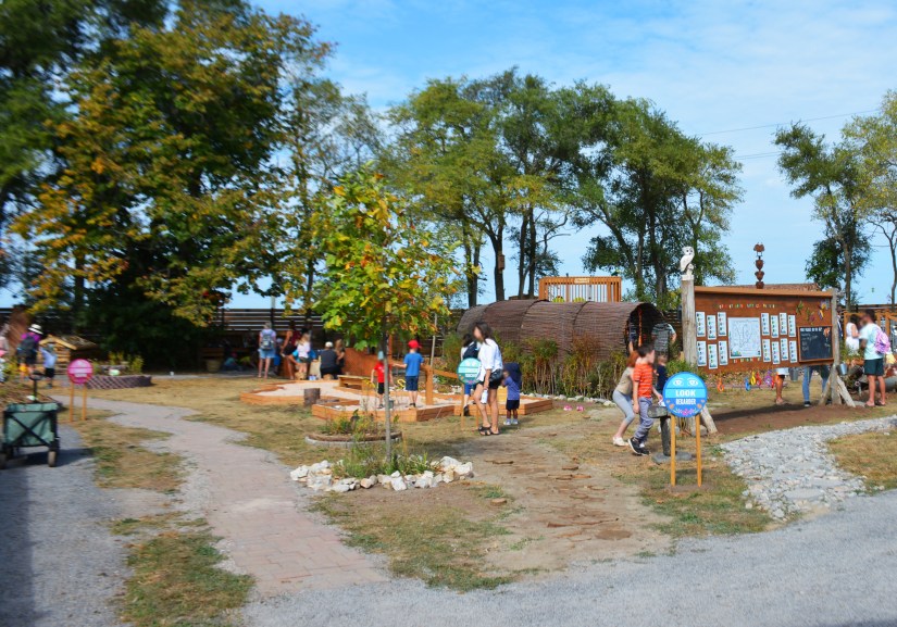 Signs by Kingston Installation Artist and an information billboard guide sensory explorers through the Sensory Garden at the 2023 Grand Opening.