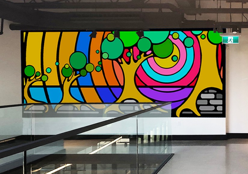 Digital mockup of a vibrant geometric tree mural proposal superimposed on the second-floor industrial office wall at Strong Enterprises Headquarters in Belleville, Ontario.